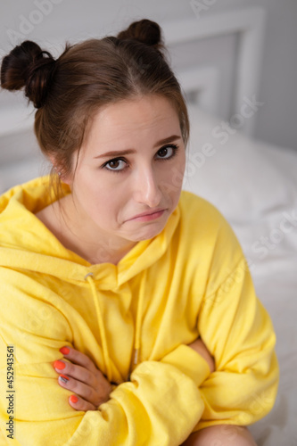 charming sweet young woman in yellow hoodie