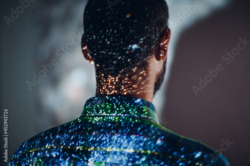Adult man in the projection of light points on his body photo