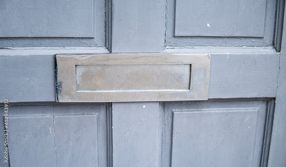 Old letterbox in the door, traditional way of delivering letters to the house, old mailbox, correspondence