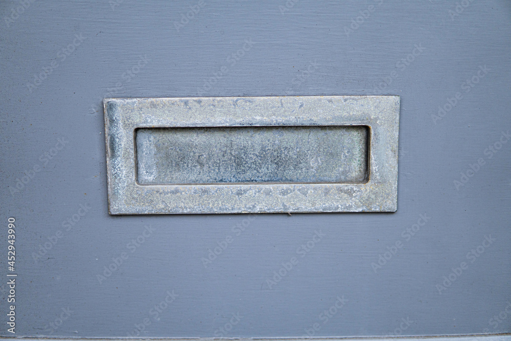 Old letterbox in the door, traditional way of delivering letters to the house, old mailbox, correspondence