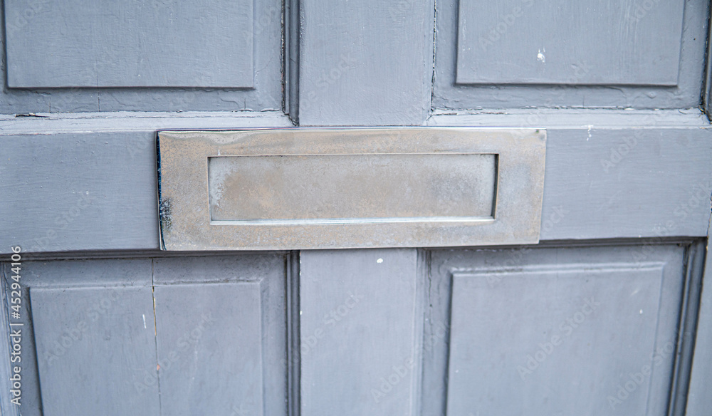 Old letterbox in the door, traditional way of delivering letters to the house, old mailbox, correspondence