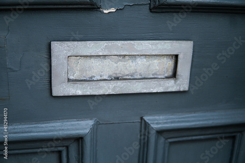 Obraz na płótnie Old letterbox in the door, traditional way of delivering letters to the house, old mailbox, correspondence
w salonie