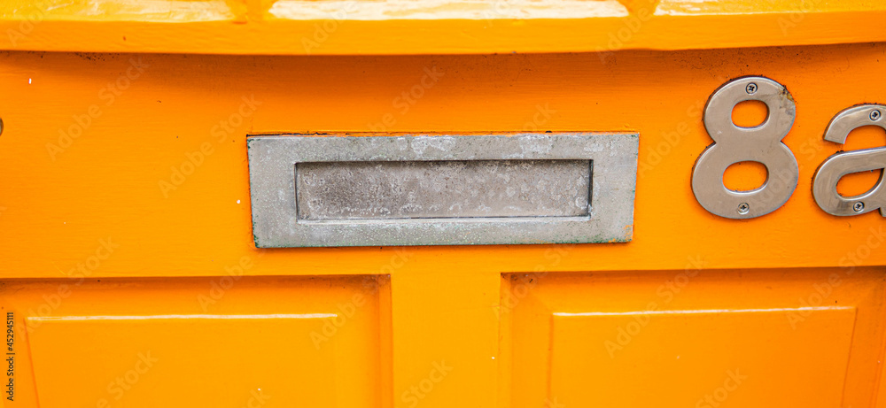 Old letterbox in the door, traditional way of delivering letters to the house, old mailbox, correspondence