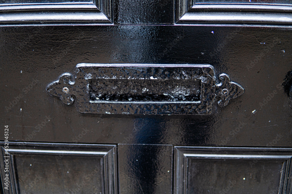 Old letterbox in the door, traditional way of delivering letters to the house, old mailbox, correspondence