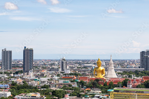 Bangkok, Thailand - 13 AUGUST 2021 : Top view of the Giant Golden Buddha in Wat Paknam Phasi Charoen Temple in Phasi Charoen district on Chao Phraya River at night, Bangkok. Urban town, Thailand. photo