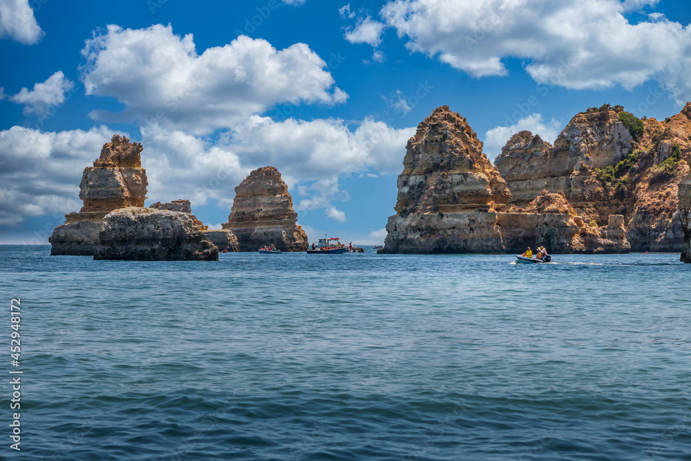 Beautiful beach of Dona Ana, Algarve - Portugal. Beach with huge cliffs at the ocean and boats