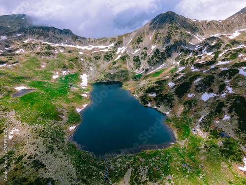 Birds eye view over glaciar lake Bucura, located in Retezat Mountains, Romania. Photography was taken with a drone from an higher angle.