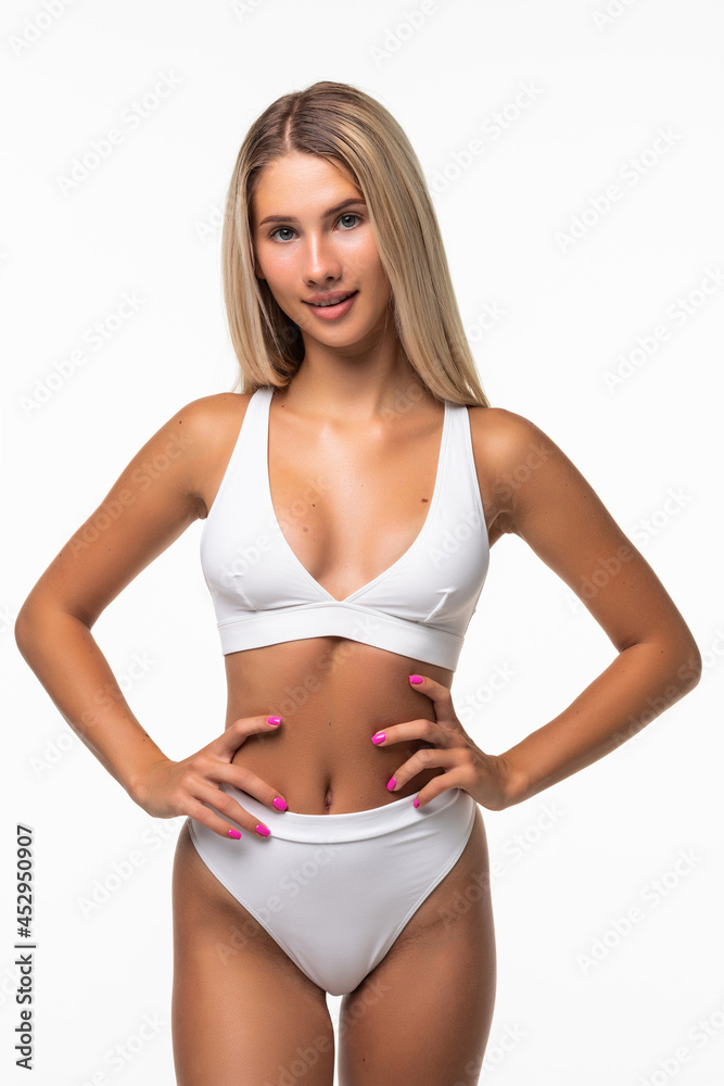 Sexy woman in white lingerie shows off her gorgeous figure isolated on white Sexy woman in white lingerie shows off her gorgeous figure isolated on white