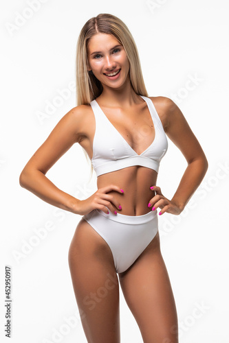 Sexy woman in white lingerie shows off her gorgeous figure isolated on white