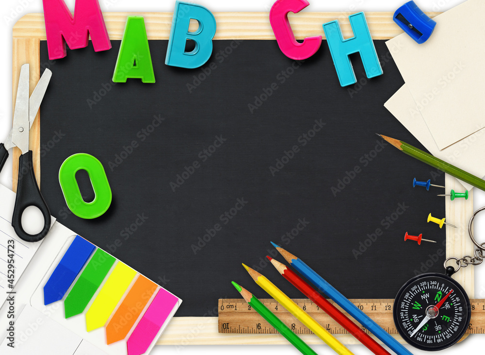 Black chalkboard with colorful school supplies as frame with copy space on white Black chalkboard with colorful school supplies as frame with copy space on white