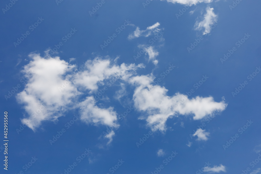 blue sky on a sunny summer day with white clouds visible on it blue sky on a sunny summer day with white clouds visible on it