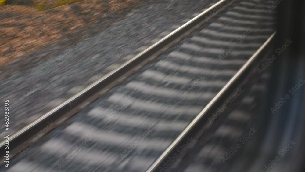 View from train window on railroad track. Train journey point of view from passenger. Rails and sleepers moving fast. 4 k video
