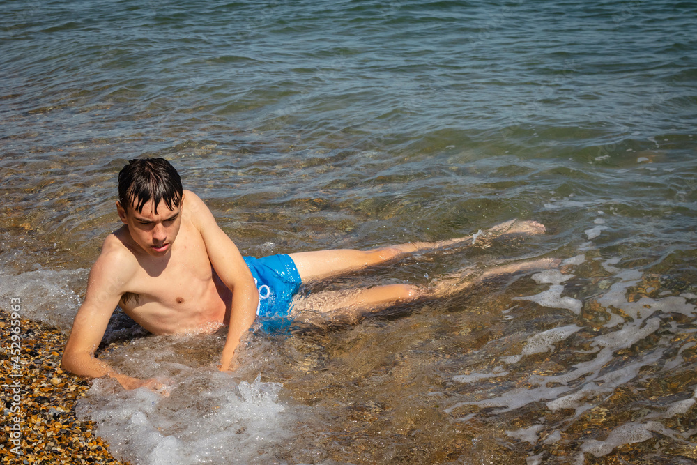 Fototapeta premium Teen boy on the foreshore