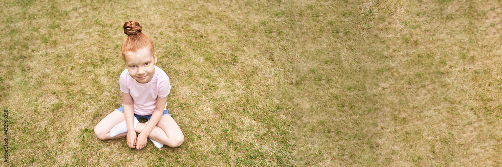 Pretty face. Red hair. Cute school child doing yoga exercise. Active vacation. Small people in lotus pose. Online video call. Happy children concept. Lifestyle action. Sport lesson Pretty face. Red hair. Cute school child doing yoga exercise. Active vacation. Small people in lotus pose. Online video call. Happy children concept. Lifestyle action. Sport lesson