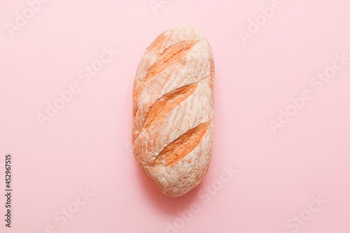Bread, pastries on a colored bright background. Bread with sesame seeds and seeds, bread texture. Delicious flavored bun.