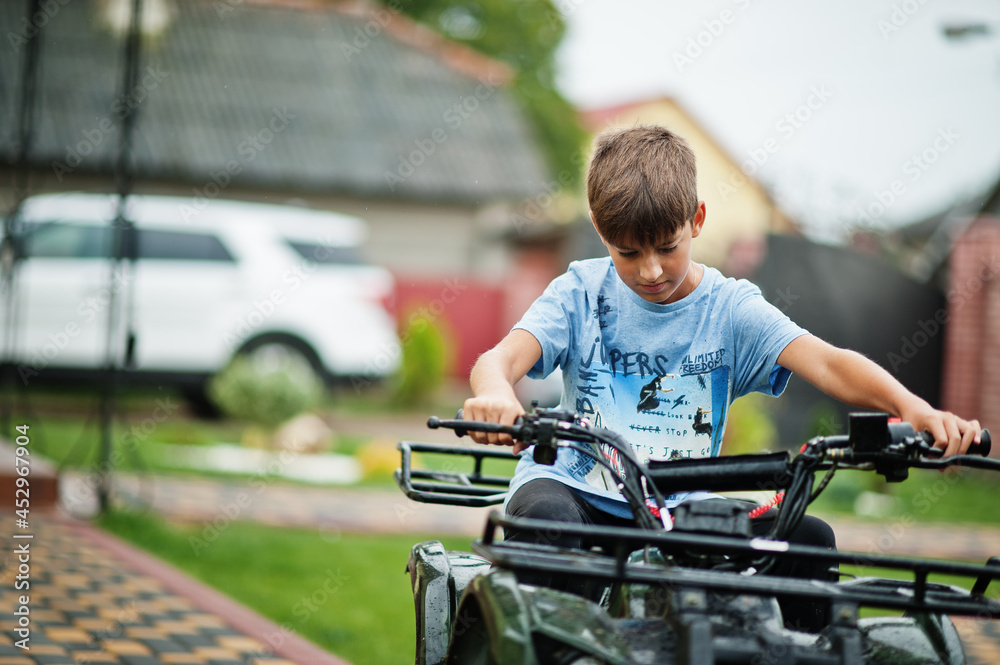 Boy in four-wheller ATV quad bike.