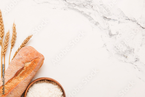 Bread, pastries on a light background. Bread with sesame seeds and seeds, bread texture. Delicious flavored bun. Lots of airy fresh bread.