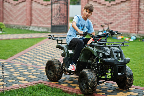 Boy in four-wheller ATV quad bike. photo