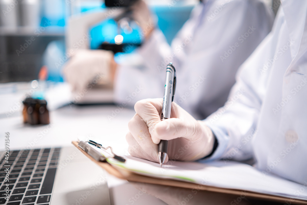 Fototapeta premium Health care researchers working in life science laboratory, medical science technology research work for test a vaccine, coronavirus covid-19 vaccine protection cure treatment