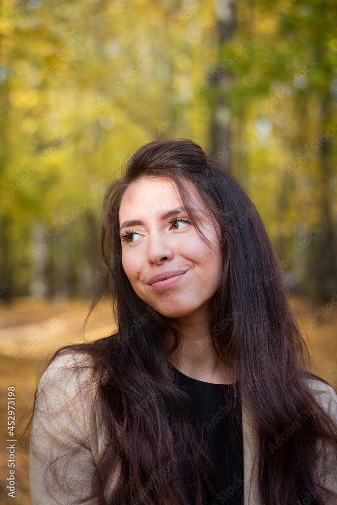 Brunette woman in autumn park. Close plan. Smiling woman. Autumn mood. Beautiful brunette. Brunette woman in autumn park. Close plan. Smiling woman. Autumn mood. Beautiful brunette.