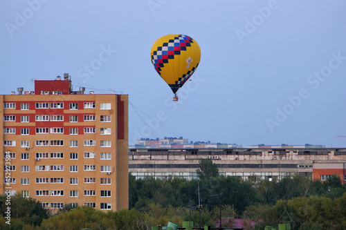 Nizhny Novgorod, Russia, 08.19.2021. A colored balloon in the sky over the city. . High quality photo