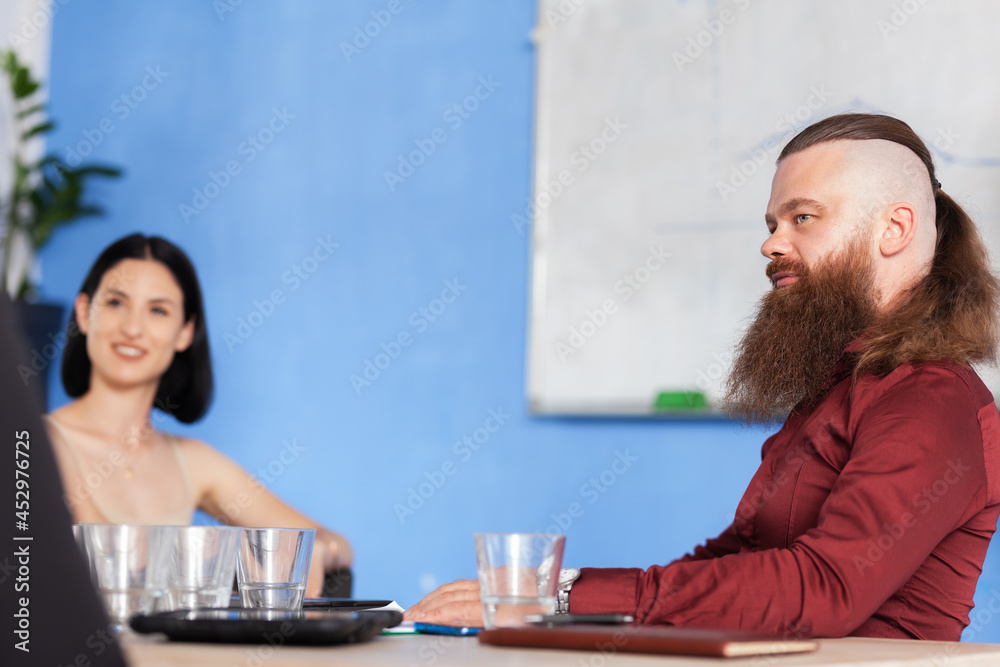 Business people having a creative meeting in an office. Businessman sitting at table. Business people having a creative meeting in an office. Businessman sitting at table.