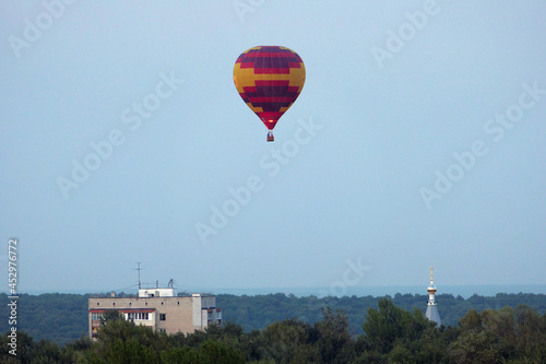  Nizhny Novgorod, Russia, 08.19.2021A colored balloon in the sky over the city. Close-up, isolated.