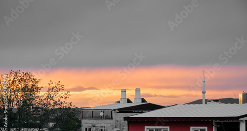 Sunset sky in cloudy day in Bursa with houses and roofs with minaret of a local mosque and radio stations. Bursa Turkey 4.4.2021.
