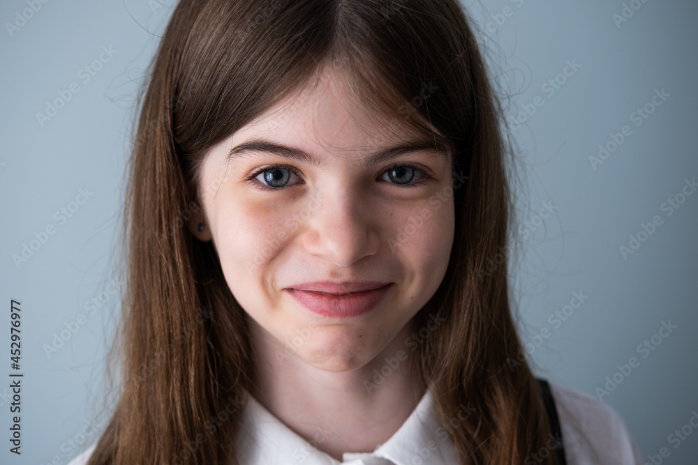 Portrait of a smiling little, young beautiful girl with big blue eyes Portrait of a smiling little, young beautiful girl with big blue eyes