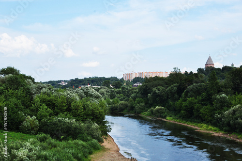 Panoramic views of the river  trees and residential buildings. Bank of the Peschaniy river. Summer day.