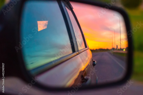 view of the beautiful road in the car mirror