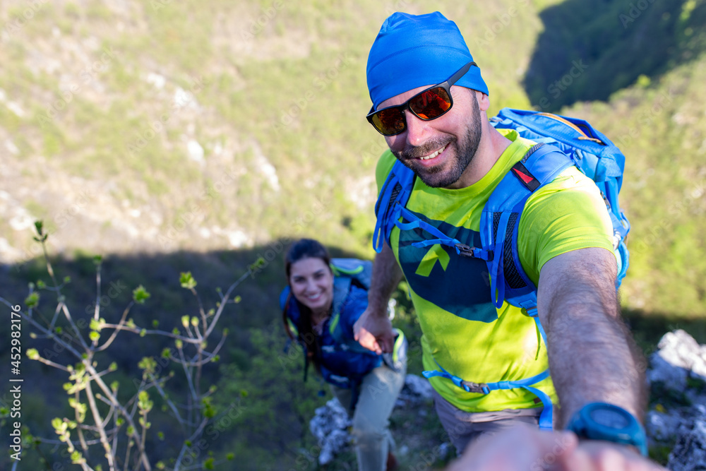 Portrait of the man and woman climbing at the mountain.