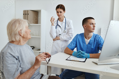 elderly woman at the hospital at the doctor's and nurse's appointment service