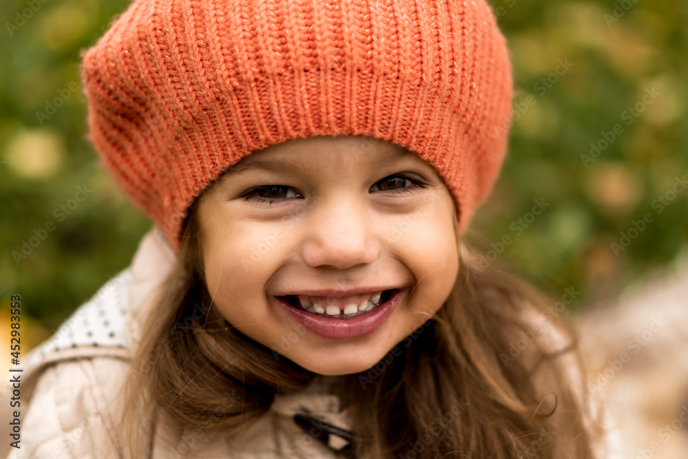 Close Up Portrait Of Little Cute Preschool Minor Girl In Orange Beret On Yellow Fallen Leaves Nice Smiling Looking At Camera In Cold Weather In Fall Park. Childhood, Family, Motherhood, Autumn Concept