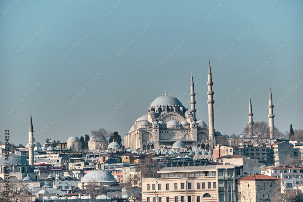 Naklejka premium Turkey istanbul 03.03.2021. Istanbul eminonu square and port with suleymaniye mosque and internal transportation ferry in istanbul bosporus and galata bridge