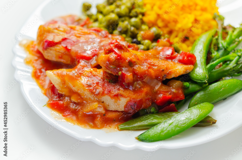 Chicken breast in a tomato and red pepper sauce with spiced long grain rice and crushed minted peas Chicken breast in a tomato and red pepper sauce with spiced long grain rice and crushed minted peas