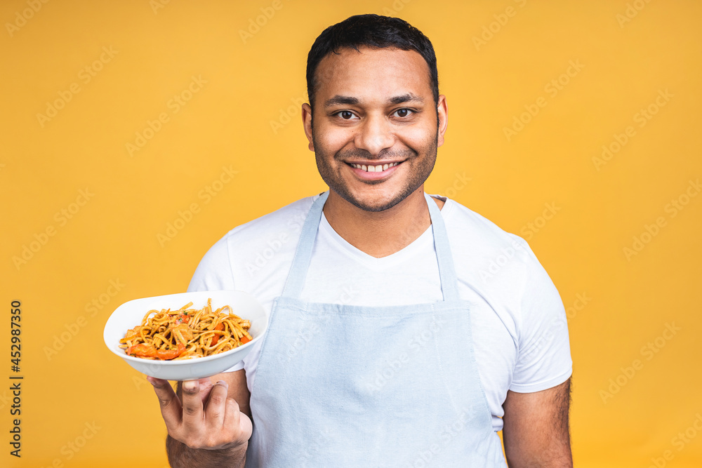 Portrait of of happy african american indian black man chef cooking pasta. Cooking, profession, haute cuisine, food and people concept isolated over yellow background. Portrait of of happy african american indian black man chef cooking pasta. Cooking, profession, haute cuisine, food and people concept isolated over yellow background.