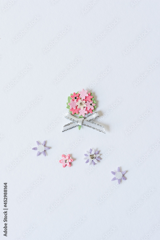 paper nosegay with silver ribbon and flowers on a light background paper nosegay with silver ribbon and flowers on a light background