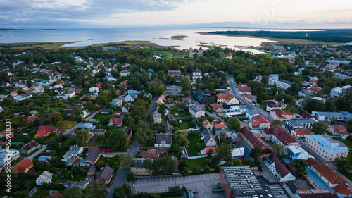 An aerial view of Kuressaare city in Saaremaa island during late August evening. Top drone view of a city by Baltic sea.