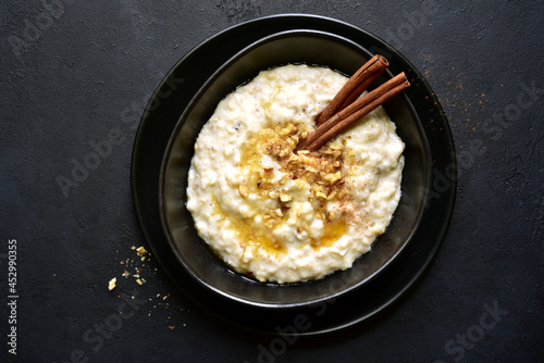 Oat porridge with nuts and maple syrup for a breakfast. Top view with copy space.