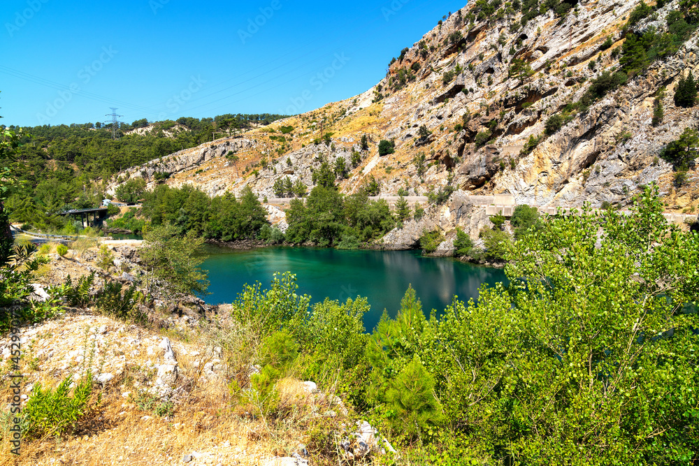 Green Canyon - one of the main attractions of Turkey. Natural beauty of Turkey. Mountains, green pines, turquoise lake. Mountain landscape with forest, trees. Beautiful mountain lake backround. Rocks.