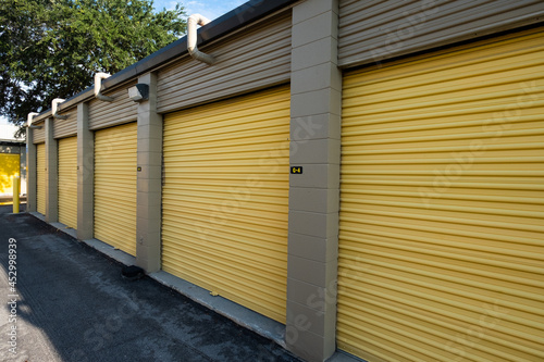 A row of garage doors at a storage unit facility