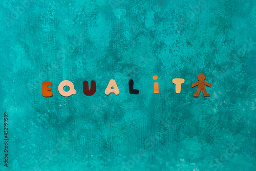 Background with the word Equality written with letters colored as the different tones of human skin photo