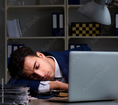 Businessman tired and sleeping in the office after overtime hour