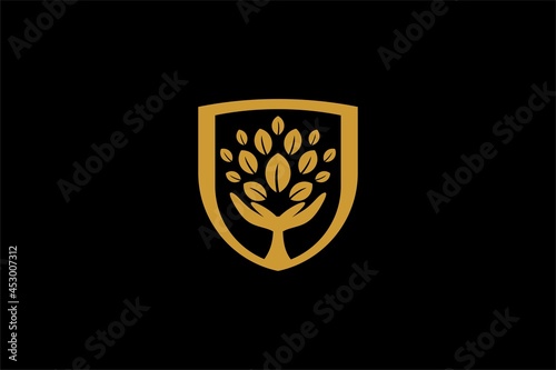 Hand tree logo design vector. Plant care illustration sign. Green leaf in shield vector icons.