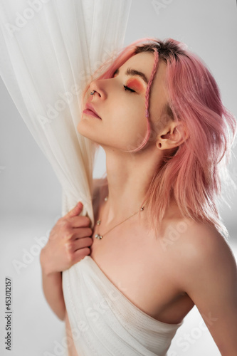 Girl with pink hair with a transparent white cloth. Tenderness.