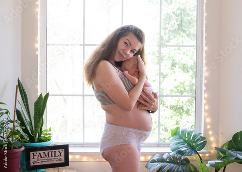 Mother with newborn baby. Postpartum. Fourth trimester. Body positivity. Postpartum body	 photo