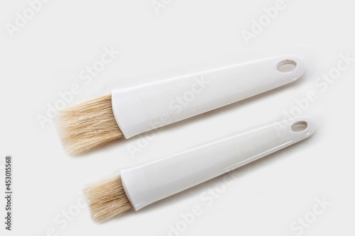 pastry brushes with ceramic handle for applying oil on fresh bread isolated on white background