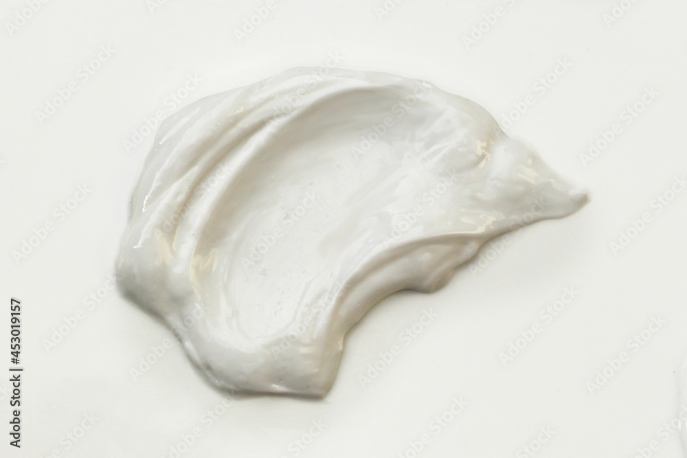 Blob or smear of white cream on a white background Blob or smear of white cream on a white background
