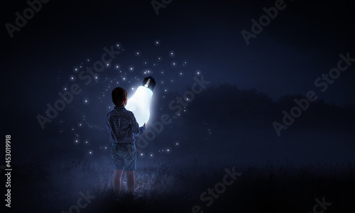 Boy with a glowing light bulb